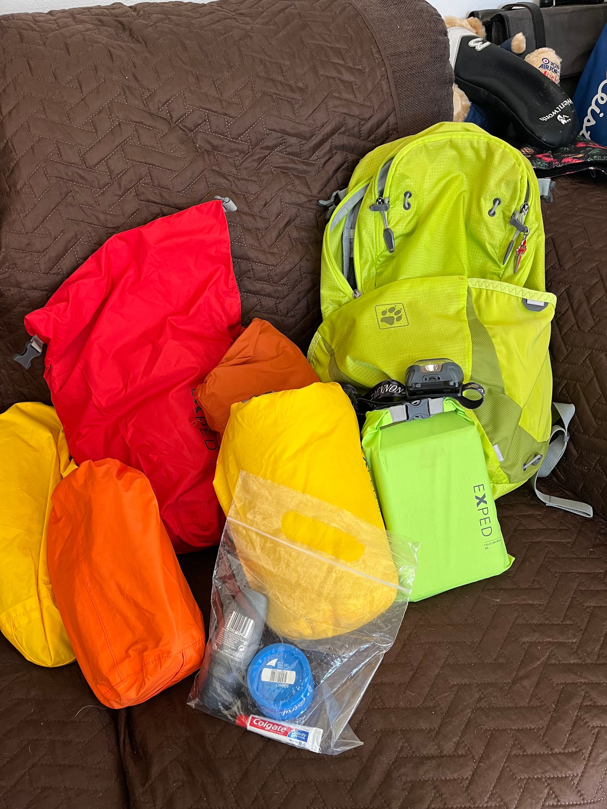 A picture of brightly coloured dry bags and a neon backpack